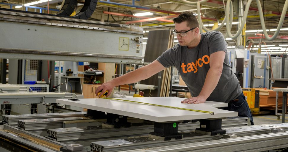 Rafal Legiezynski operating machinery in plant